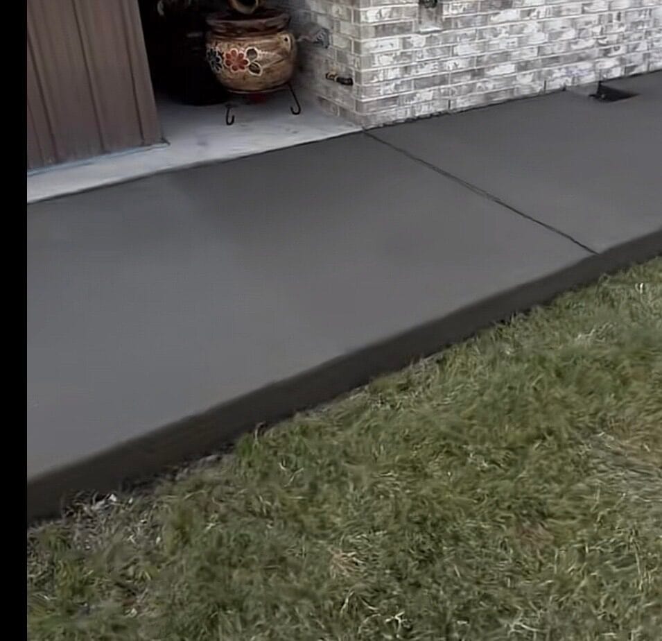 New concrete add-on poured flush with the existing covered patio slab at a Waxahachie TX home