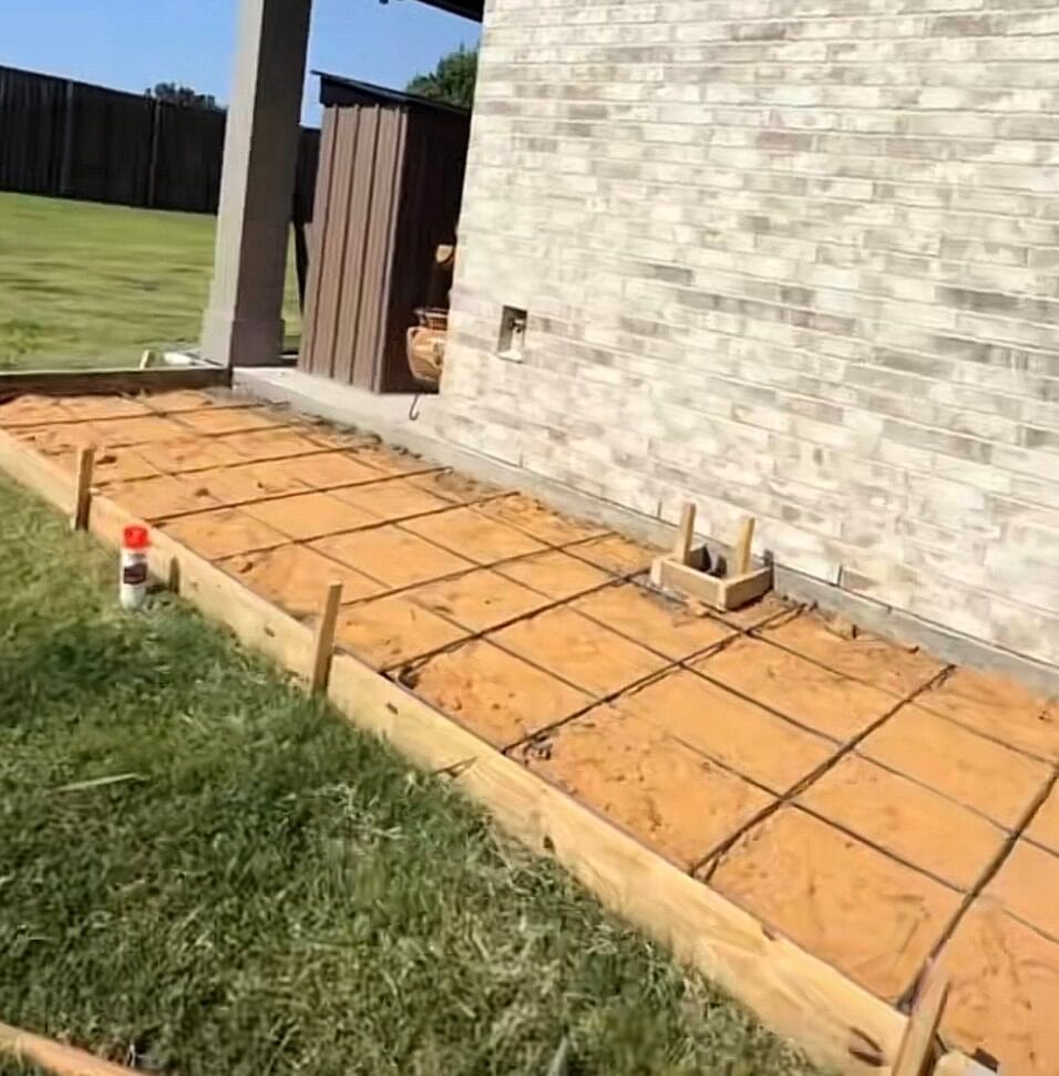 Wood forms and rebar grid set on a sand base before pouring the concrete add-on slab, Waxahachie TX