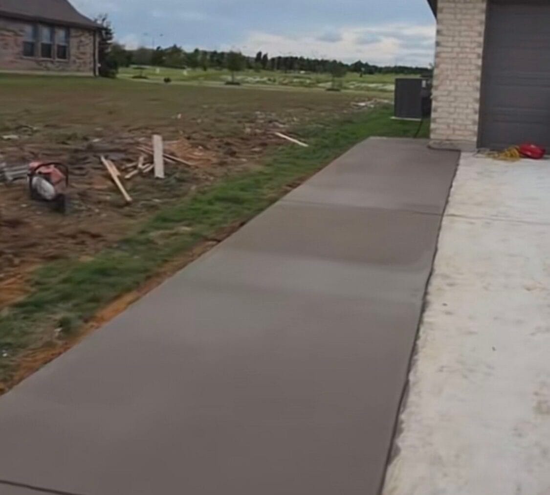 New concrete driveway extension poured flush against the existing drive at a Waxahachie TX home