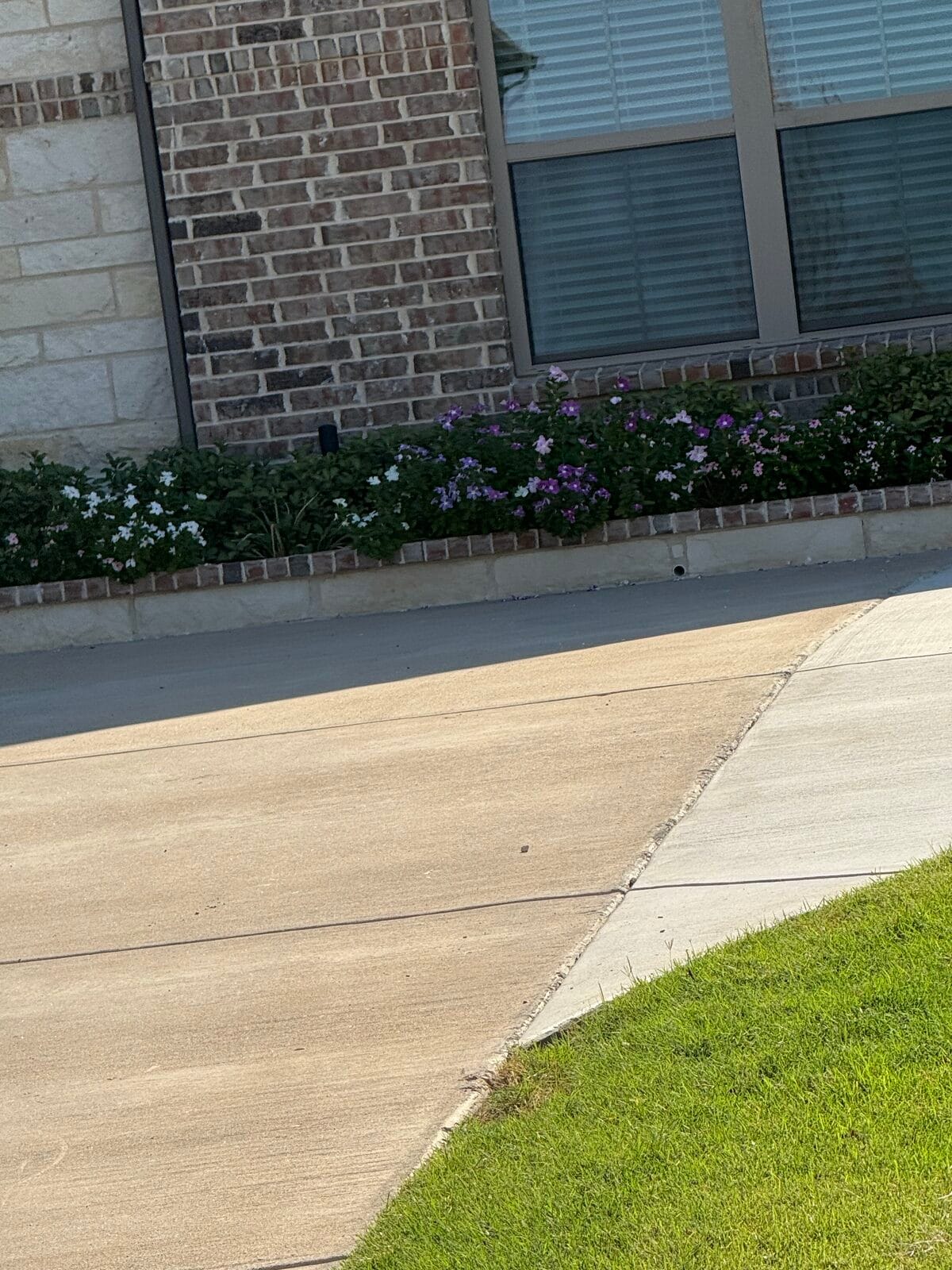Widened concrete driveway extension tying into the existing drive at a brick home in Glenn Heights TX