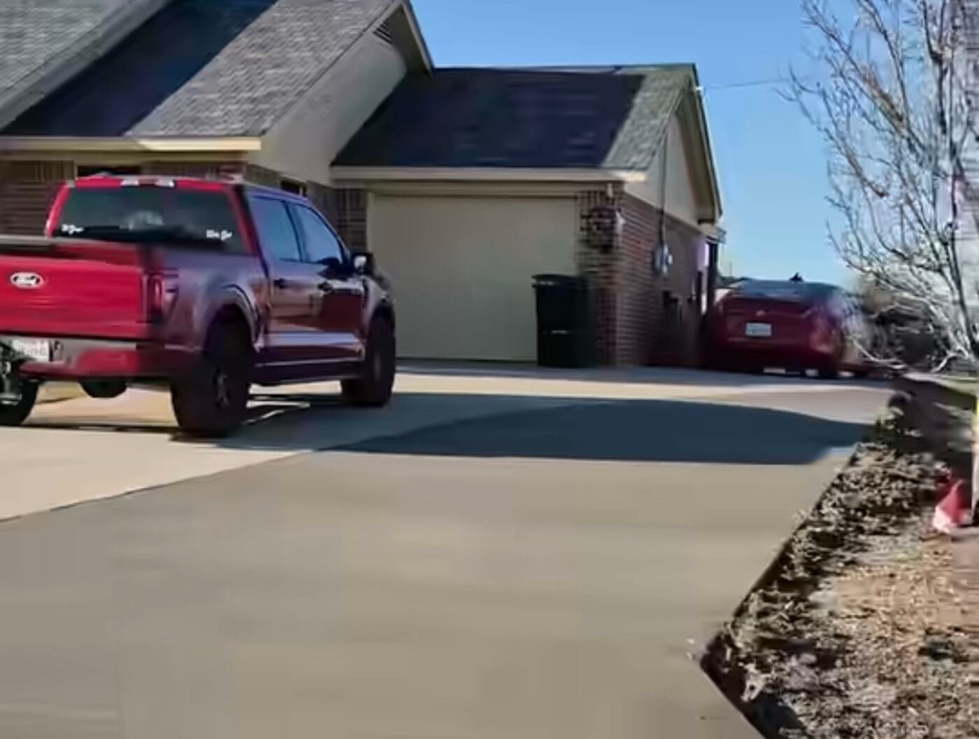 Freshly poured concrete extension slab beside a brick home in Waxahachie TX