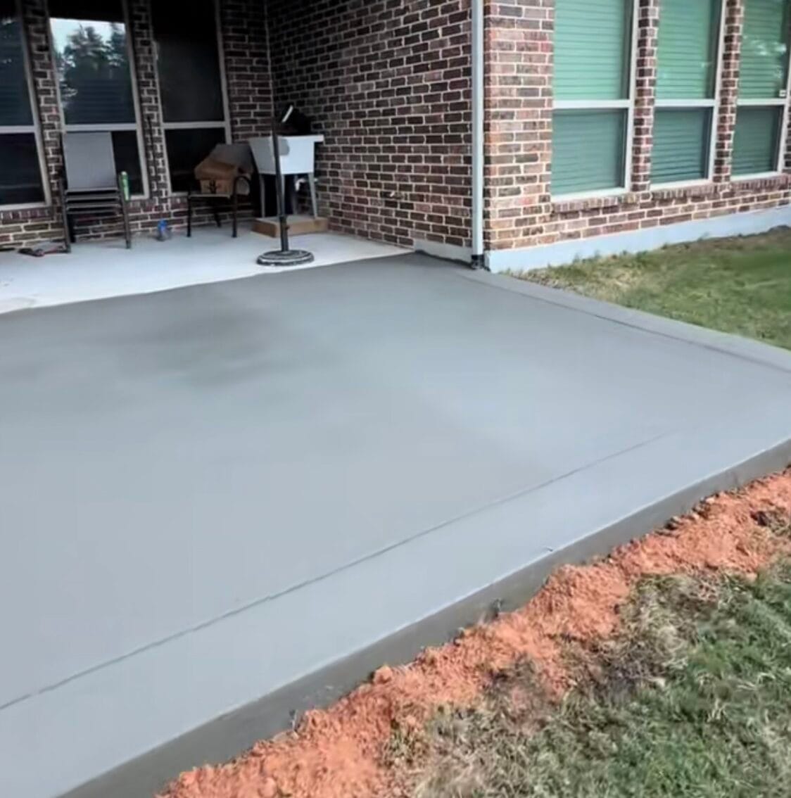 New concrete patio slab with a smooth finish and tooled edge tying into the covered porch, Waxahachie TX