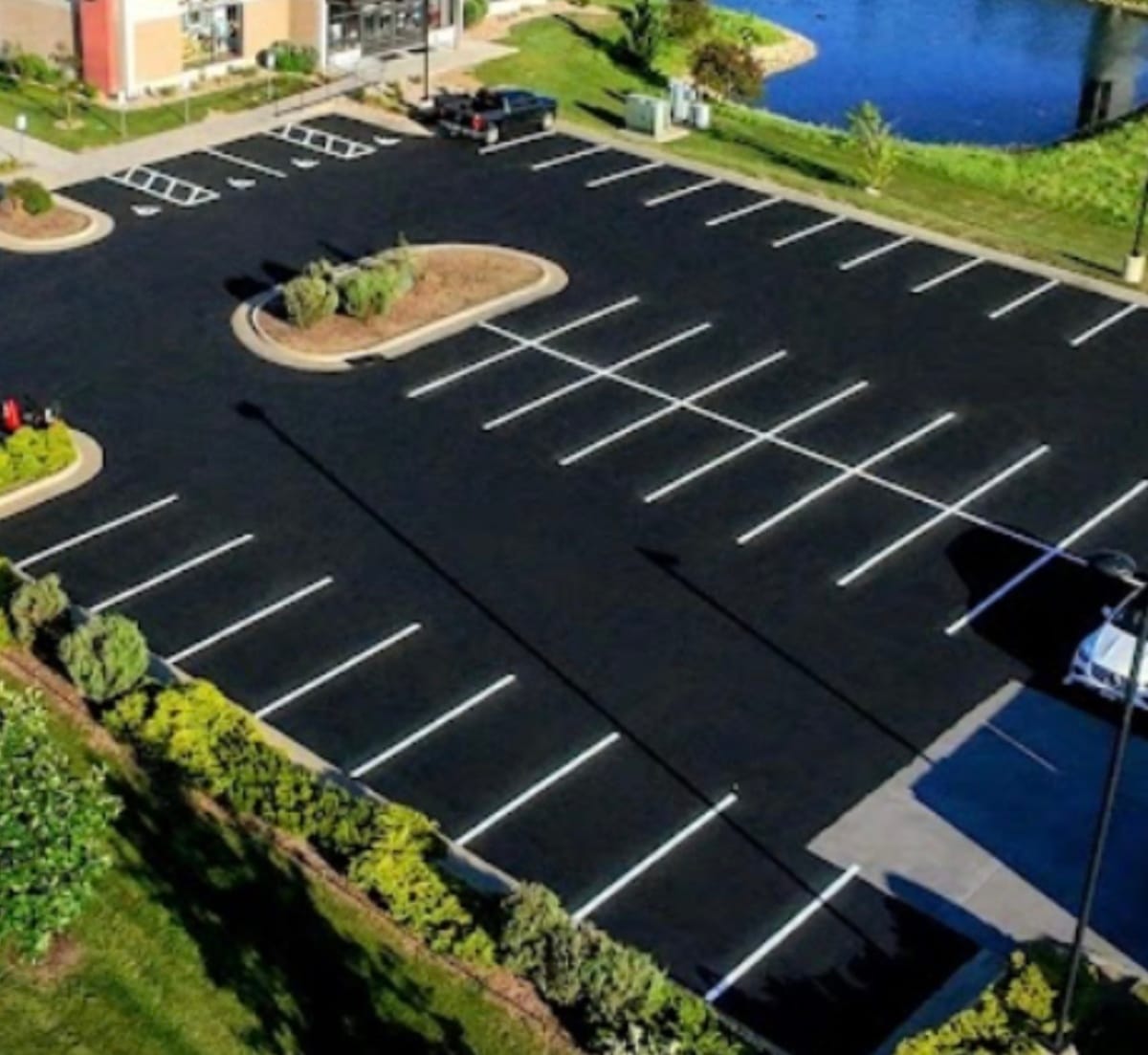 Aerial view of freshly paved and striped commercial parking lot